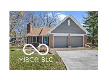 Charming single-story home featuring a brick facade, two-car garage, and well-maintained front yard at 11336 Bloomfield Ct, Indianapolis, IN 46259