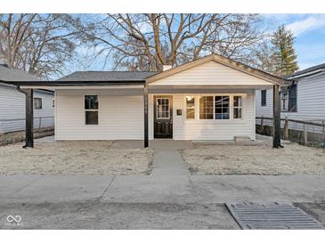 Charming exterior of a home featuring a covered porch and a freshly painted white exterior at 1209 N Centennial St, Indianapolis, IN 46222