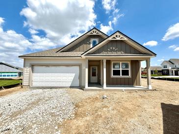 Charming single-story home featuring a garage and a welcoming front porch, set against a blue sky with scattered clouds at 1419 School Bell Dr, Greenwood, IN 46143