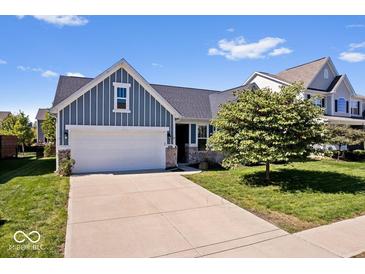 Charming single-Gathering home featuring blue siding, a two-car garage, and a well-manicured lawn at 15773 Eastpark Dr, Noblesville, IN 46060