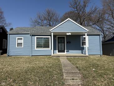 Charming single-story home featuring light blue siding and a welcoming front porch entrance at 1618 W 17Th St, Anderson, IN 46016