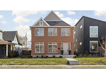 Charming two-story brick home featuring symmetrical windows and a well-maintained front yard at 2031 Central Ave, Indianapolis, IN 46202