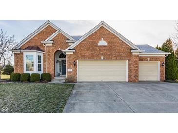 Charming brick home featuring a two-car garage, landscaped front yard, and inviting entrance at 405 Letterman Dr, Brownsburg, IN 46112