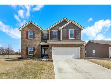 Attractive two-story home with a brick and siding facade, a two-car garage, and an inviting front yard at 491 Tracewood Bnd, Greenfield, IN 46140
