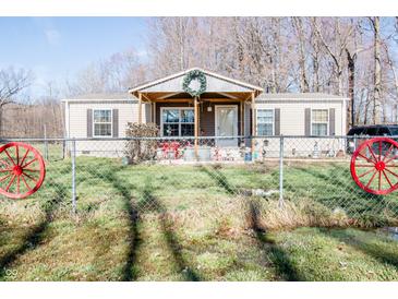 Charming single-story home with a welcoming front porch and decorative wreath at 5010 S 550 W, Columbus, IN 47201