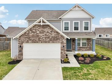 Charming two-story home with a brick facade and well-maintained landscaping, showcasing a welcoming curb appeal at 5520 N Woodside Ct, McCordsville, IN 46055