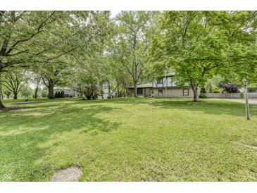 Expansive front yard with mature trees surrounding a two-story house at 569 King Dr, Indianapolis, IN 46260