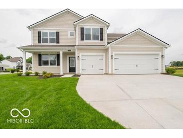 Charming two-story home with a well-maintained lawn and an attached two-car garage at 5908 Agogo Way, Greenwood, IN 46143