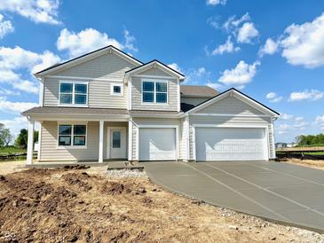 Charming two-story home featuring a two-car garage and a classic design with light neutral colors at 5908 Agogo Way, Greenwood, IN 46143