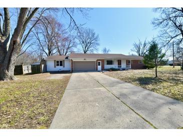Charming ranch-style home with a well-manicured front yard and a long driveway at 7953 Forest Park Dr, Indianapolis, IN 46217