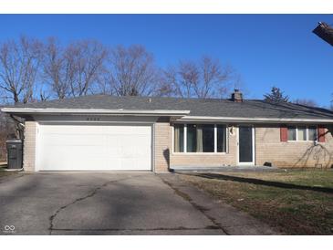 Ranch-style home with a large two-car garage and brick facade at 8137 S Delaware St, Indianapolis, IN 46227