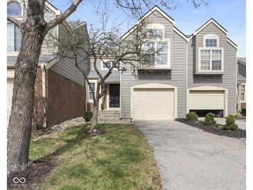 Charming townhouse with gray siding, attached garage, and well-maintained front yard at 9459 Wimbledon Ct, Indianapolis, IN 46250