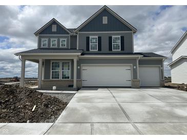 Two-story home showcasing a three car garage and a stylish gray exterior at 16429 Mount Logan Rd, Noblesville, IN 46060
