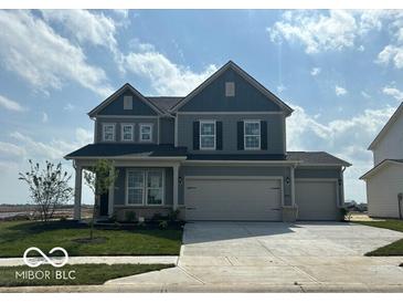 Charming two-story home with two-car garage, well-maintained lawn, and inviting curb appeal at 16429 Mount Logan Rd, Noblesville, IN 46060