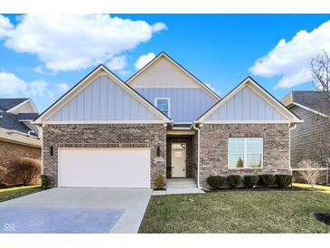 Charming brick home featuring a two-car garage and beautifully landscaped front yard at 2199 Somerset Dr, Franklin, IN 46131