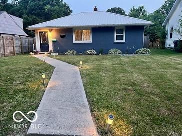 Charming single-story home featuring a well-maintained lawn and inviting walkway at 245 E Plum St, Anderson, IN 46012