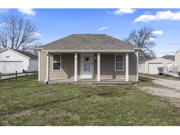 Charming one-story home featuring a covered porch, neutral siding, and a well-maintained front lawn under a clear blue sky at 3022 Alice Ave, Indianapolis, IN 46237