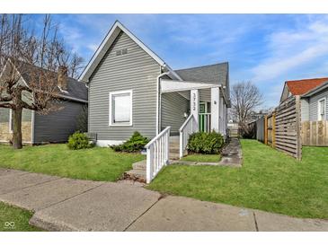Charming gray home with a well-manicured lawn and inviting front porch with white railings at 3732 N Kenwood Ave, Indianapolis, IN 46208