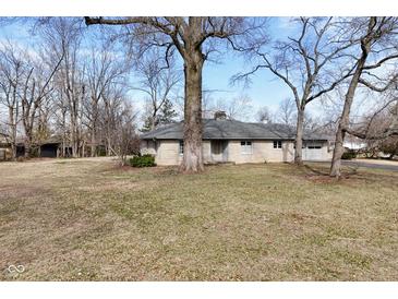 Charming single-story home featuring a long driveway and a beautiful lawn and mature trees at 616 Gibbs Ct, Plainfield, IN 46168