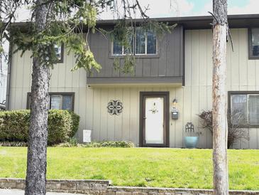 Charming townhome with a well-manicured lawn and inviting front entrance at 7902 Benjamin Dr, Lawrence, IN 46226