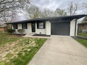 Charming single-story home featuring a paved driveway and freshly painted exterior at 10225 Bayton Ct, Indianapolis, IN 46229