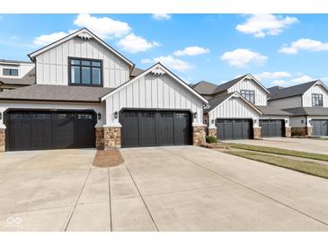 Charming townhouses with gray garages, stone accents, and white siding offer curb appeal at 10744 Eldorado Cir, Noblesville, IN 46060