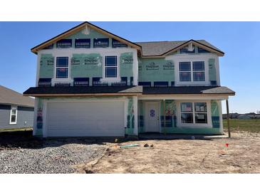 New two-story home features an attached two-car garage and covered entryway, still under construction at 1265 Fleming Dr, Greenfield, IN 46140