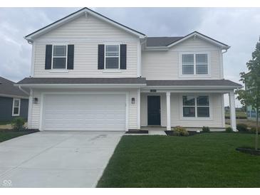 Charming two-story home featuring a well-manicured lawn, attached garage, and classic architectural details at 1265 Fleming Dr, Greenfield, IN 46140
