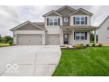 Charming two-story home featuring a spacious three-car garage and well-manicured front lawn at 1618 Trichel Dr, Greenwood, IN 46143