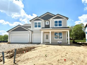 Charming two-story home with a two-car garage and manicured lawn under a blue sky at 1618 Trichel Dr, Greenwood, IN 46143