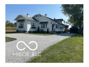 Charming, cottage-style home with gravel driveway and well-manicured lawn in a quiet, rural setting at 5951 W St Rd 32 W, Anderson, IN 46011