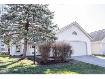 Charming single-Gathering home featuring white siding, attached garage, and a lovely landscaped front yard at 9303 Aintree Dr, Indianapolis, IN 46250