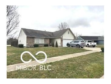 Well-maintained single-story home with a two-car garage and tidy front lawn and driveway at 1001 Maple W Dr, Lebanon, IN 46052
