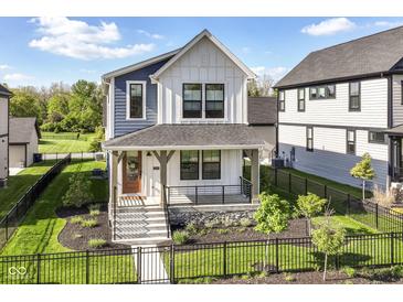 Attractive two-story home featuring a well-manicured lawn and inviting front entrance at 11505 Langton Walk, Zionsville, IN 46077