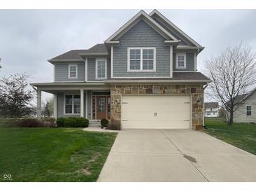 Charming two-story home with stone accents, a covered porch, and a well-maintained lawn at 13820 N Honey Creek Dr, Camby, IN 46113