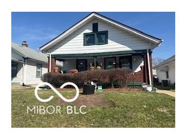 Charming single-story home with a covered front porch and well-maintained lawn, great curb appeal at 1405 N Mount St, Indianapolis, IN 46222