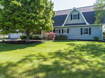 Charming home with gray siding, mature trees, and a well-manicured lawn at 3548 W 500 North Rd, McCordsville, IN 46055