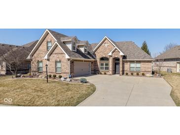 Charming brick home featuring manicured landscaping, a two-car garage, and a welcoming driveway at 3792 Waterfront Way, Plainfield, IN 46168