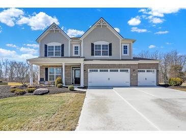 Charming two-story home featuring a three-car garage and well-manicured front lawn at 4052 Saddle Club S Pkwy, Bargersville, IN 46106