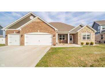 Charming single-story brick home with a three-car garage and well-maintained lawn at 4720 W Tradwell Dr, New Palestine, IN 46163