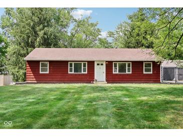 Charming home with a red exterior, well-maintained lawn, and a inviting white front door and trim at 4754 E 64Th St, Indianapolis, IN 46220