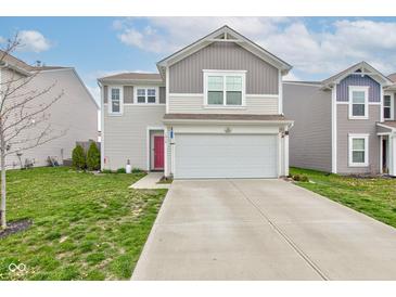 Charming two-story home with a two-car garage, a red front door, and a well-manicured lawn at 1012 Balto Dr, Shelbyville, IN 46176