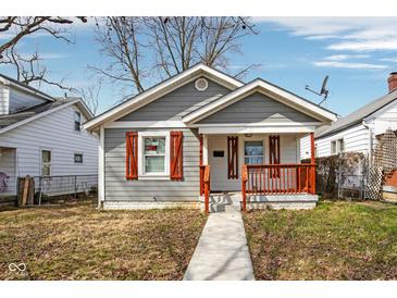 Charming single-story home features gray siding, red shutters, and a cozy front porch at 1540 N Chester Ave, Indianapolis, IN 46201