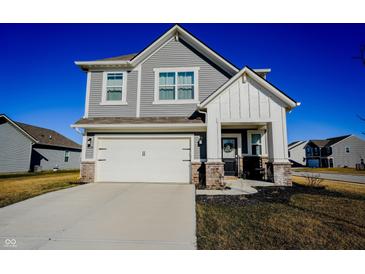 Charming two-story home with gray siding, white trim, and a two-car garage under a clear blue sky at 2349 Dixon Creek Dr, Whitestown, IN 46075