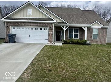 Charming single-story home featuring a well-maintained lawn, two-car garage, and inviting front porch at 2536 Lanai Ln, Greenwood, IN 46143