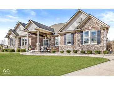 Charming single-Gathering home with a beautifully manicured lawn and attractive stone and brick exterior at 3342 Challenger Dr, Plainfield, IN 46168