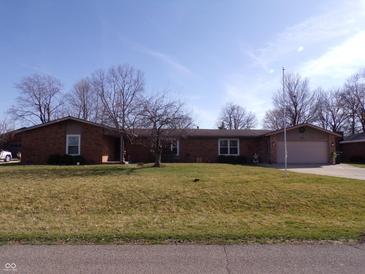 Charming single-story brick home with a well-maintained lawn and mature trees at 4013 Colonial Dr, Anderson, IN 46012