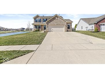 Charming two-story home with brick facade, wide driveway, and landscaping at 5806 Belvista Dr, Plainfield, IN 46168