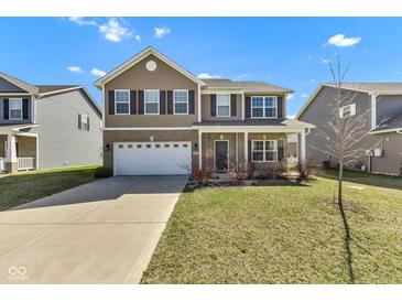 Inviting two-story home with a well-manicured lawn and attached two-car garage at 8153 Fivespot Ln, Plainfield, IN 46168