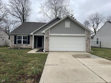 Charming single-story home featuring a two-car garage and neutral exterior at 125 Hilltop Farms Blvd, Whiteland, IN 46184